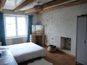 a bedroom with a bed and a fireplace at Maison en bord de mer - Plougastel-Daoulas - 6 à 8 personnnes in Plougastel-Daoulas