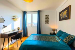 a bedroom with a bed and a desk and a window at Jolie T5 familial 10p in Coulaines