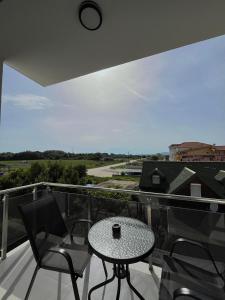 a patio with a table and chairs on a balcony at Street Apartments in Ulcinj