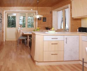 a kitchen with a table and a dining room at Haus König in Bezau