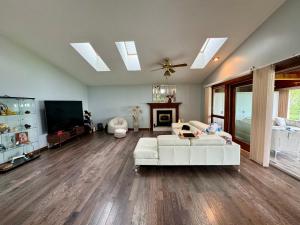 a living room with a white couch and a tv at Home away on Lake Ontario in Youngstown