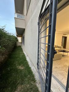 an external gate to a house with a patio at Glamorous Spacious 3BR at Jardin de Carthage Tunis in Sidi Daoud