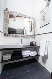 a bathroom with a sink and a mirror at Casa Rural La Rosalia in Cogolludo