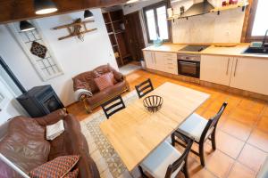 a living room with a table and a couch at Casa Rural La Rosalia in Cogolludo