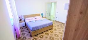 a bedroom with a bed with two pink pillows at Villa Pina in Vico Equense