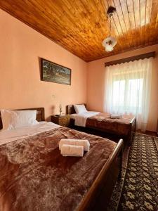 a bedroom with two beds and a wooden ceiling at Rustic House in Miléa