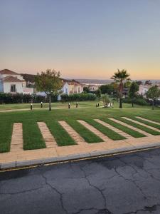 a field of grass with trees and a street at Casa Pez in Ayamonte