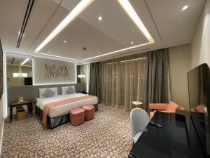 a hotel room with a bed and a television at Vivienda Hada Residences in Riyadh +31 photos
