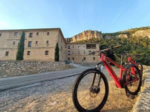 a red bike parked on the side of a road at Casa Las Peñuelas in Priego