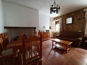 a living room with a table and a couch at Casa Las Peñuelas in Priego