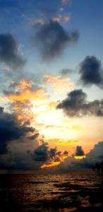 a cloudy sky over the ocean at sunset at Cabañas La Cuchita RNT 61621 in Coveñas