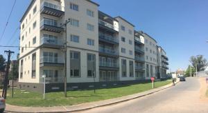 un grand immeuble blanc au bord d'une rue dans l'établissement Del Sol Dto 210, à Pinamar