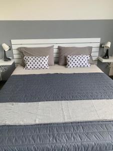 a large bed with two pillows in a bedroom at Son Sogni Holiday House in Leggiuno
