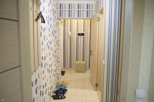 a hallway with a room with a toilet and a tile floor at Apartment Decebal in Chişinău