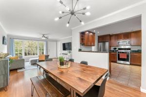 a kitchen and living room with a wooden dining table at Picture-Perfect Charmer in North Decatur in Decatur