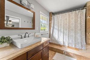 a bathroom with a sink and a mirror at Picture-Perfect Charmer in North Decatur in Decatur