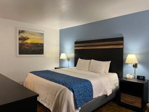 a hotel room with a bed and two lamps at Travelodge by Wyndham Truth or Consequences in Truth or Consequences