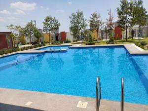 a large swimming pool with blue water at Exclusiva Casa con Alberca in Bata