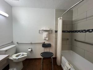 a bathroom with a sink and a toilet and a bath tub at Travelodge by Wyndham Truth or Consequences in Truth or Consequences