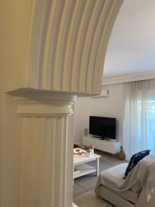 a living room with a couch and a television at New Best Priced Walkable Beach Sites City Rhodes Town Apartment in Rhodes Town