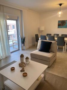 a living room with a couch and a table at New Best Priced Walkable Beach Sites City Rhodes Town Apartment in Rhodes Town