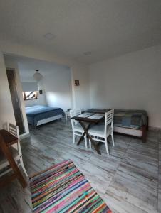 a room with a table and a bed and a table and chairs at Casa cronopio in Ushuaia