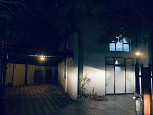 a building at night with a door and a plant at 23 On Jupiter in Polokwane