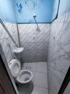a small bathroom with a toilet and a shower at Pousada Terra do Sol in Fortaleza +14 photos