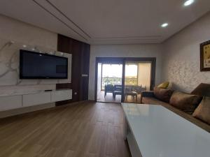 TV a/nebo společenská místnost v ubytování Fenêtre sur le paradis