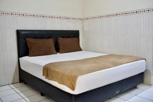 Letto o letti in una camera di Garuda Setia Hotel