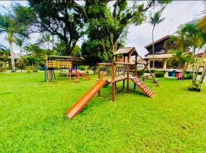 a playground with a slide in a park at Maresias Cond Club Alto padrão Frente Praia in São Sebastião
