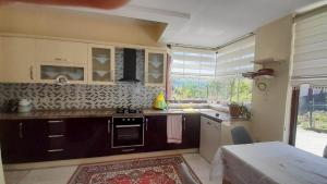 a kitchen with a sink and a stove top oven at Atlas6161 in Trabzon