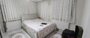 a small bedroom with a bed with a book on it at Atlas6161 in Trabzon