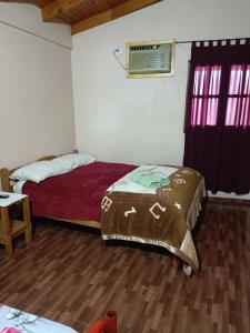 Ein Bett oder Betten in einem Zimmer der Unterkunft Hostel el Amanecer