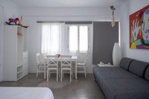 a living room with a table and a couch at Kyon Beach Suites Kythnos in Kanala