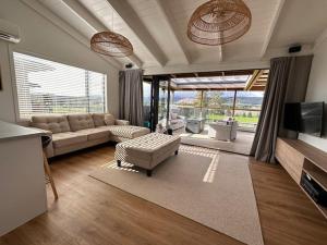 a living room with a couch and a tv at The Lake Haus in Mangakino