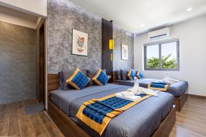 Postel nebo postele na pokoji v ubytování Hai Hội Villa Hoi An