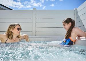 two girls are playing in a hot tub at Lyons Manor House in Maryport