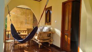 a room with a hammock in a room at Ananda B&B in Gili Air