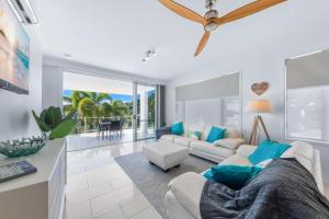 a living room with a couch and a table at Airlie Summit Apartments in Airlie Beach