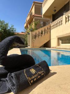 a pile of towels sitting next to a swimming pool at Elite residents sheikh zayed in Sheikh Zayed