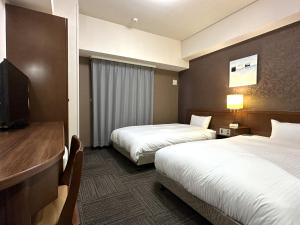 Postel nebo postele na pokoji v ubytování Hotel Route-Inn Yaizu Inter