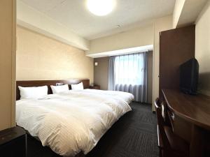 Postel nebo postele na pokoji v ubytování Hotel Route-Inn Yaizu Inter