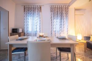 a dining room with a table and chairs and a couch at Tramonto D'oro in Gallipoli