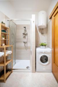 a washing machine in a bathroom with a shower at Tramonto D'oro in Gallipoli