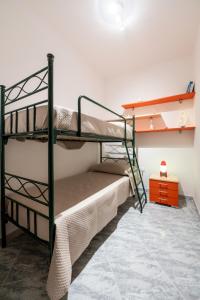 a bedroom with two bunk beds and a table at Tramonto D'oro in Gallipoli