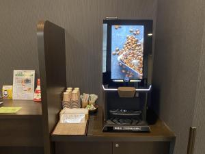 a counter with a drink dispenser in a hotel room at Hotel Route-Inn Uozu in Uozu