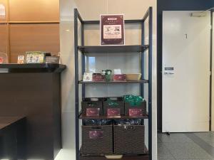 a shelf with food items on it in a store at Hotel Route-Inn Uozu in Uozu