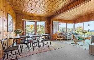 a living room with tables and chairs and a couch at Lovely Home In Hundested With Wifi in Hundested