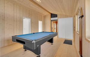 a pool table in a room with wooden walls at 4 Bedroom Beautiful Home In Slagelse in Slagelse
